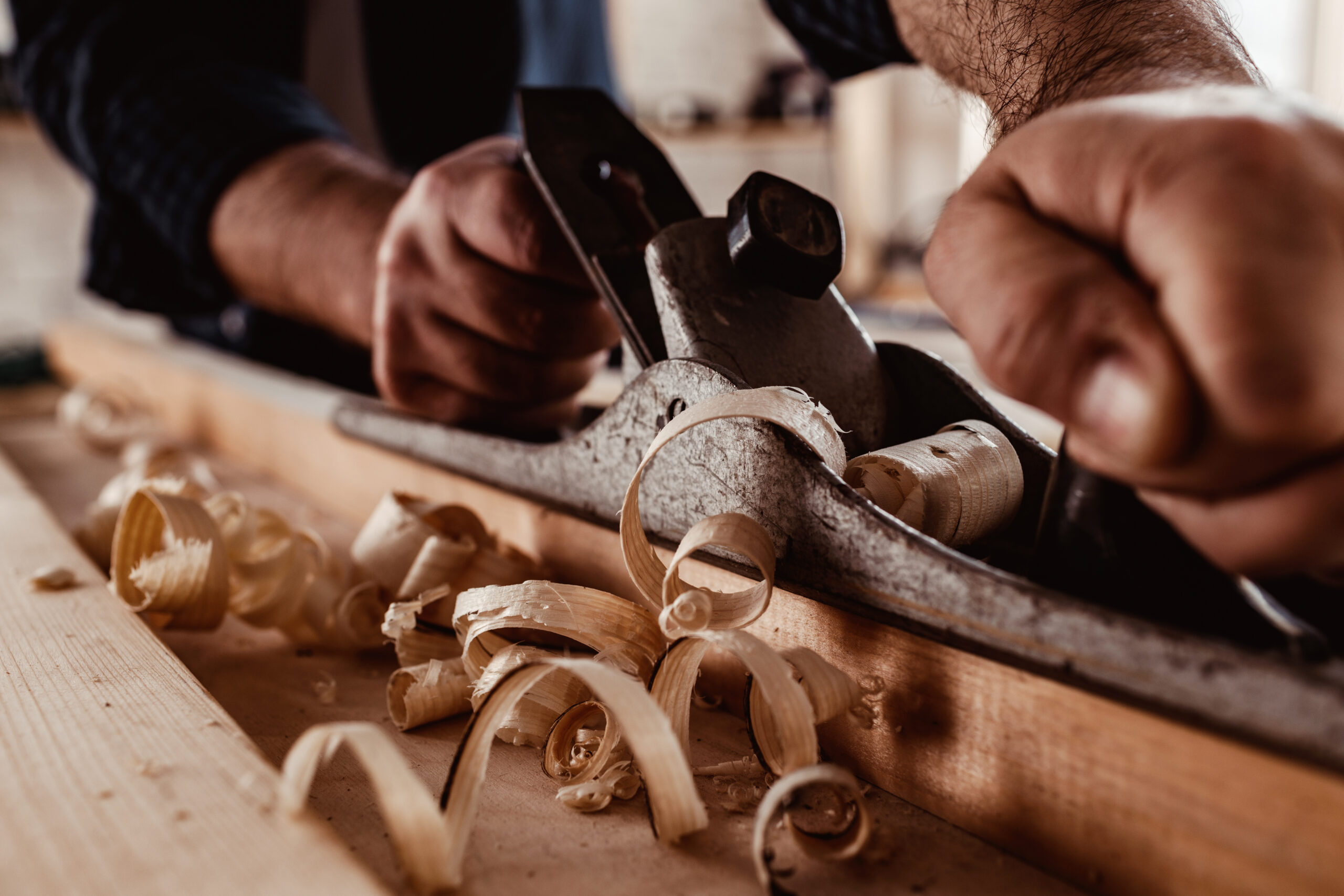 Carpenter’s,Hands,Planing,A,Plank,Of,Wood,With,A,Hand